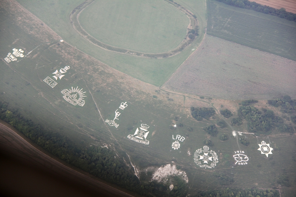 The Fovant Badges: Regimental badges cut into the chalk hillside near Fovant, Wiltshire during WW1 by soldiers camped nearby.  The Chiselbury Iron 
				 Age hillfort is visible at the top of the photo.