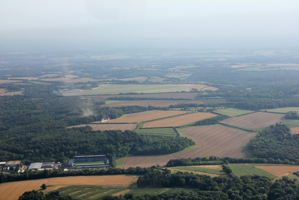 Booker Airfield (aka Wycombe Air Park) is the green field just above centre. The 'smoke' rising up from the trees is actually 
				dust from a combine harvester in the field.