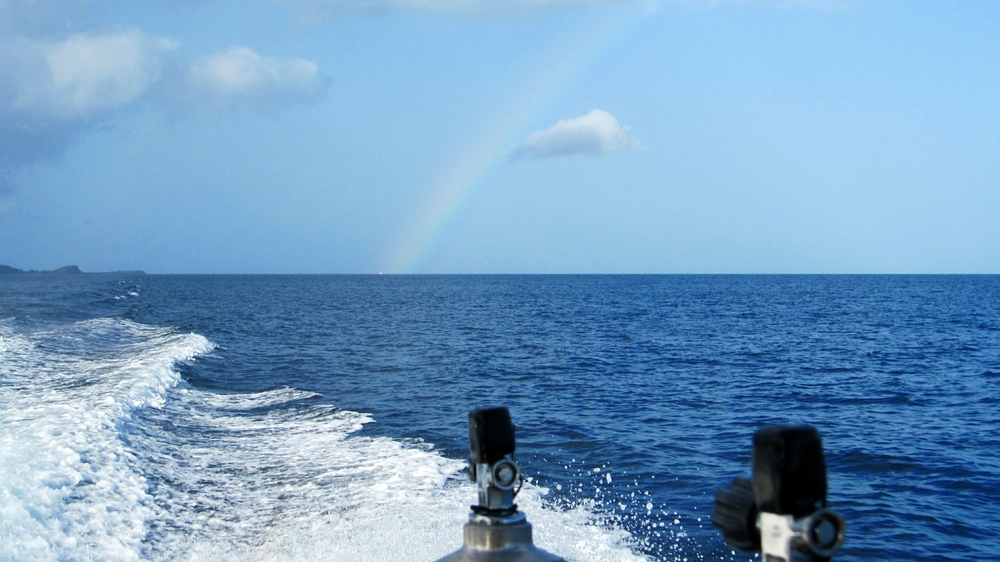 As we head out to a dive site, we leave a rainbow behind us.