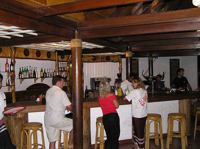 Robin, the Indian head barman, serves thirsty guests at the main bar. (67k)
