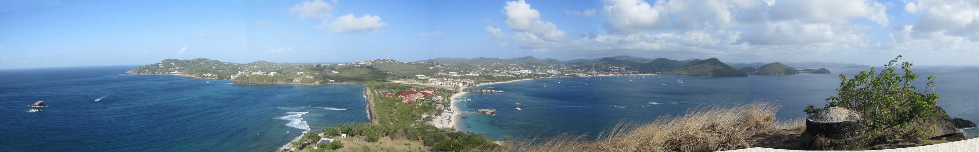 Panoramic view from Signal Peak on Pigeon Island - Cap Estate to the left, the red roofs of Sandals in the middle on the causeway,
        and Rodney Bay on the right.