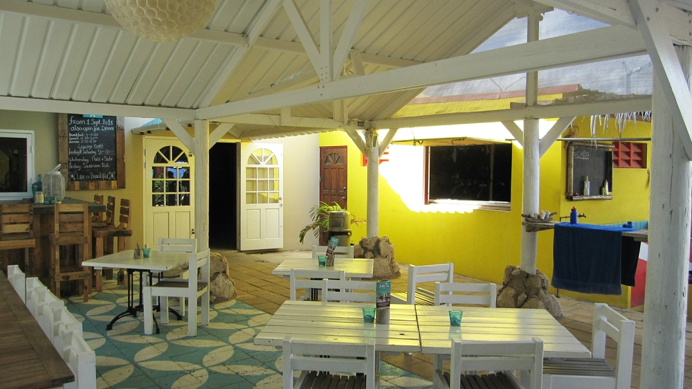 Aqua Windies courtyard. There's a restaurant to the left, the equipment counter at middle right, and some rinse tanks at far right.