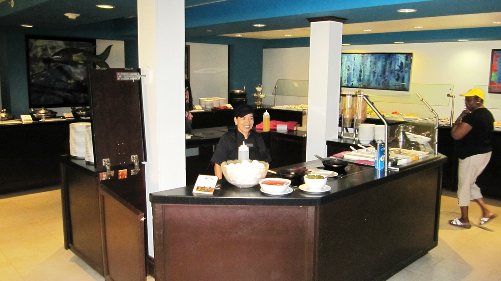 The cheerful lady at the omelette station at Laguna's at breakfast.