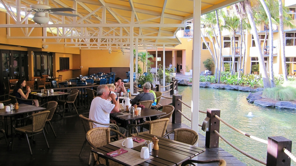 You could take breakfast indoors or outside on this terrace overlooking the lagoon stuffed full of carp.