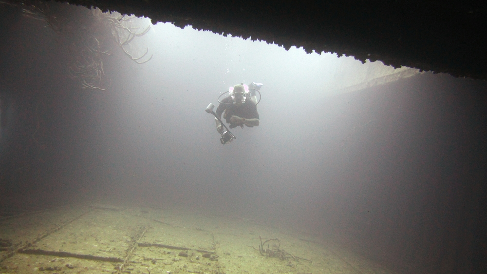 Another diver follows me into the empty hold of the Jane C.