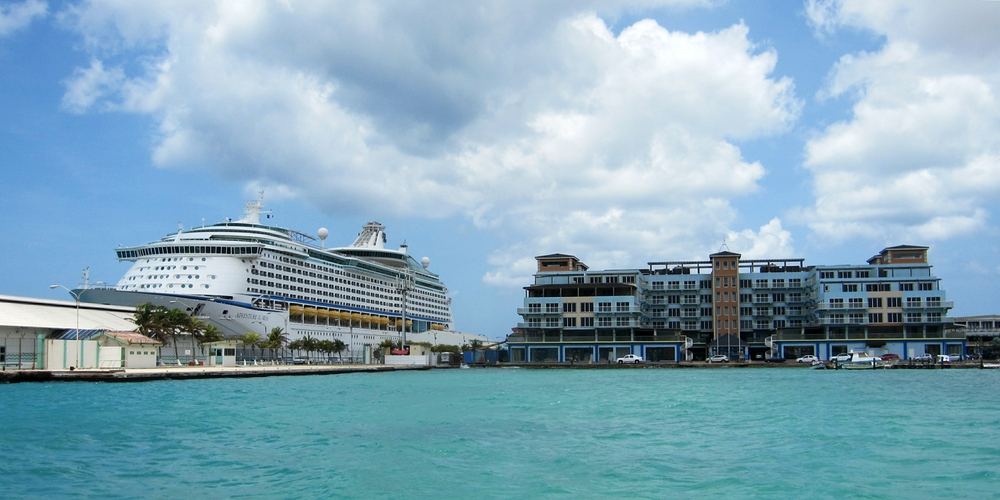 The cruise liner towers over the adjacent shopping mall.