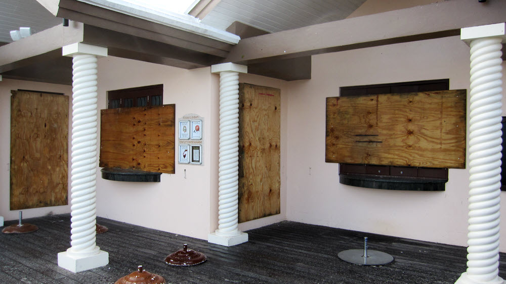 Hurricane boards have already been nailed up over sea-facing windows.