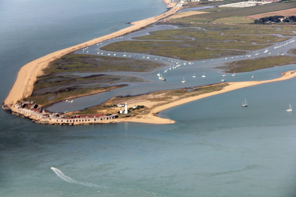 Hurst Castle from above Yarmouth, IoW. A large battery of guns was set up by Henry VIII in the low buildings to protect the western approaches 
					to the Solent. The fortress is slightly distorted by the curvature of the window.