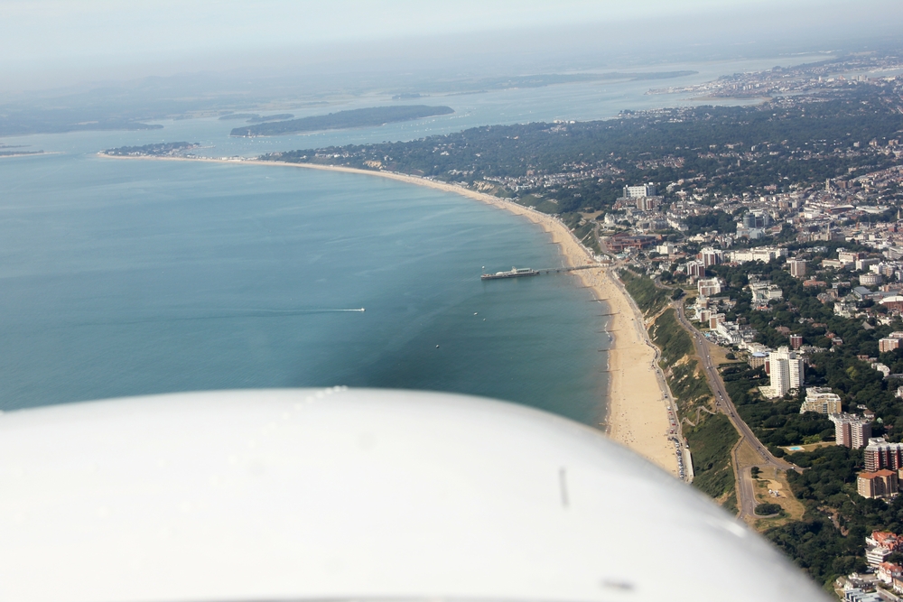 A magnificent view looking west through the propellor along Bournemouth Beach, showing the town at the right, and the Pier dead ahead.  Poole 
					Bay is to the left and Poole Harbour in the distance.