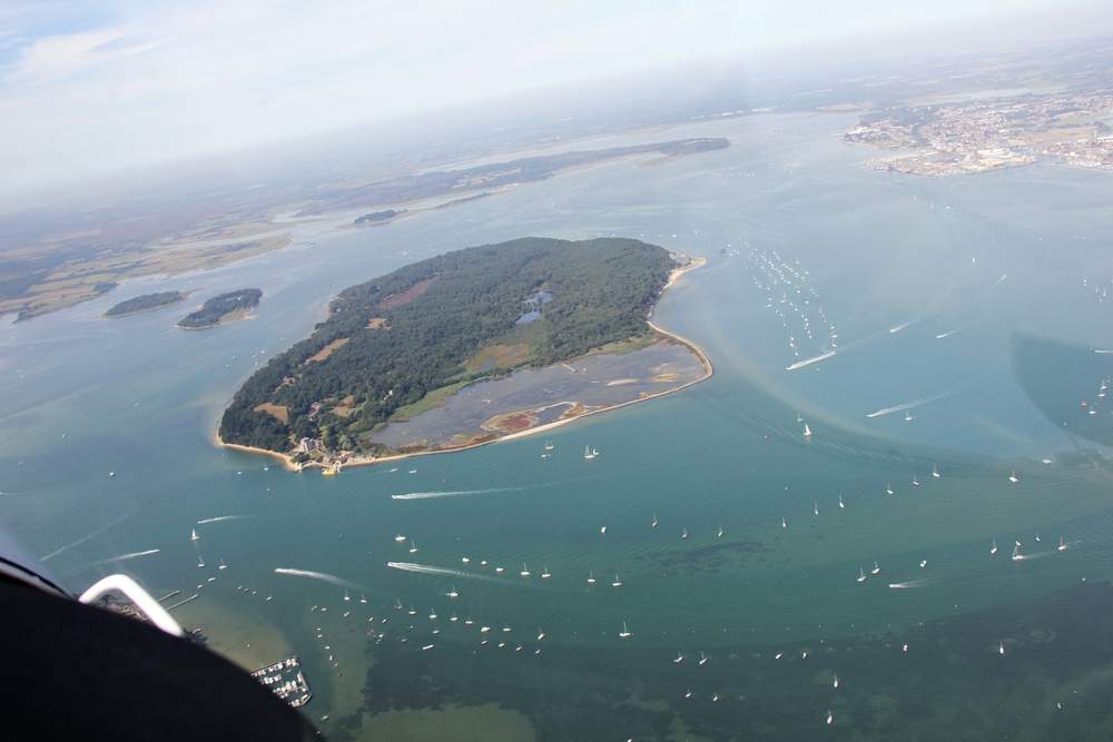 Looking north from above Sandbanks over Brownsea Island in Poole Harbour. Poole itself is at top right.
