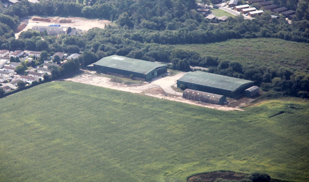 These two large green buildings are all that remains of RAF Warmwell - two aircraft hangars, now used as storage barns by a 
					local farmer. There also seems to be a Nissen hut.