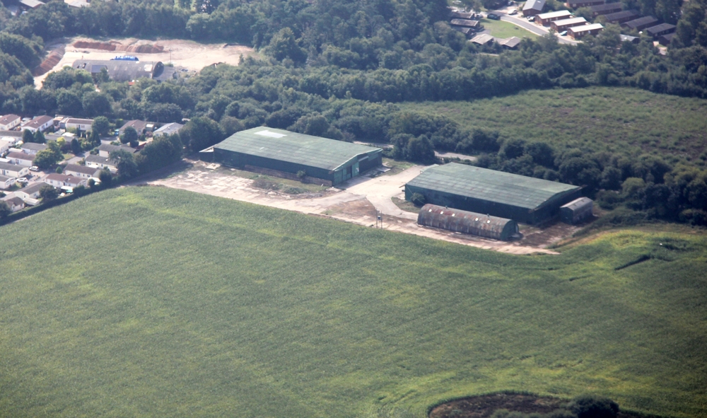 These two large green buildings are all that remains of RAF Warmwell - two aircraft hangars, now used as storage barns by a 
					local farmer. There also seems to be a Nissen hut.