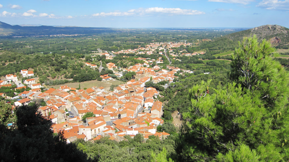 The new town of Corbère on the other side of the Chateau, as seen from the chapel. The thin blue line of the Mediterranean 
				is barely visible on the horizon to the right.