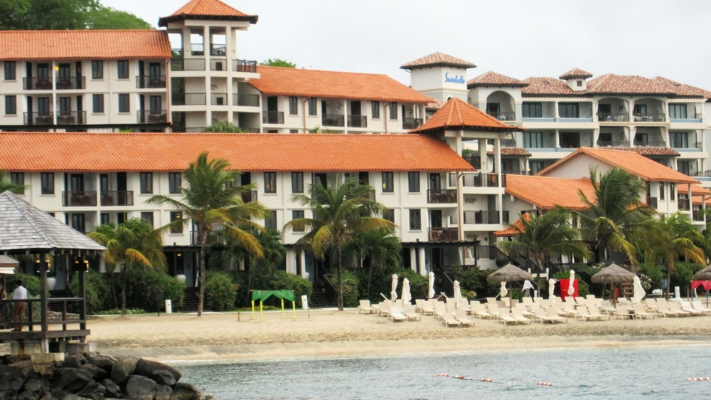 Our room in the Pink Gin building, just to the right of centre, to the right of the two palm trees on the second storey next to the stairs down to the beach.