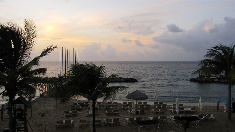 Looking straight forward from our balcony at sunset. The flags of the Caribbean nations where Sandals have a presence fly from these flagpoles by day. 