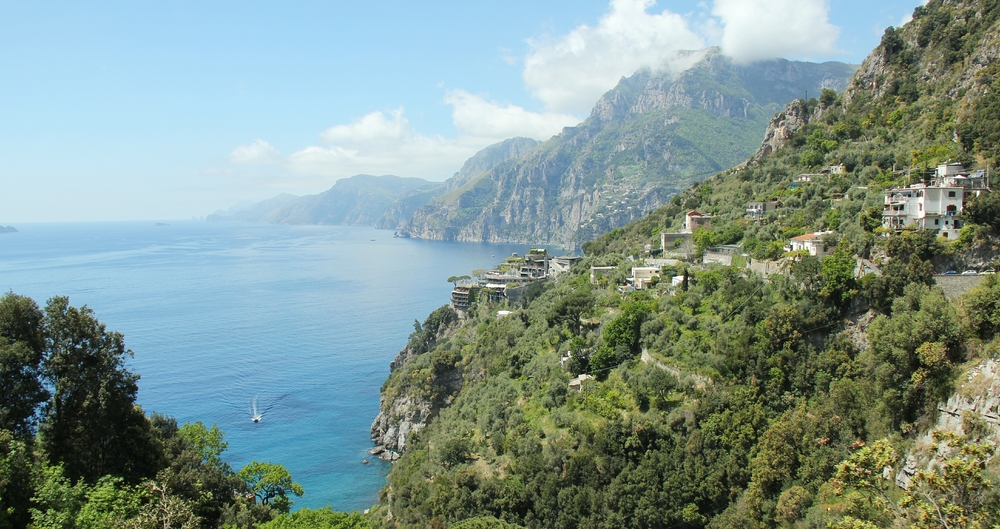 A hotel built into the rock perches precariously over the sea.