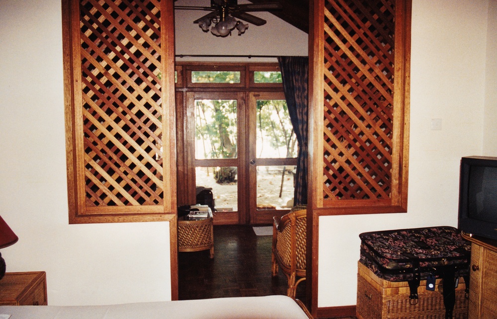 Looking back from the bedroom into the lounge area, and through the front windows out onto the beach.