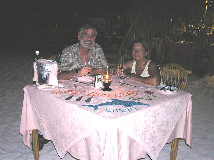 Our waiter decorated the table with a greeting in coloured rice on Linda's birthday. (61k)