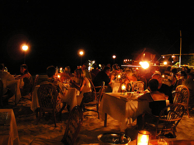 One evening we all ate on tables set up on the beach under the stars. (99k)
