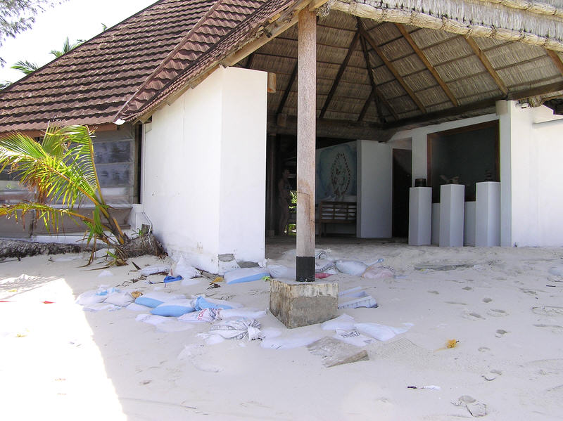 Sandbag walls protecting a corner of Reception. During stormy weather before our arrival, waves were coming into reception. (95k)
