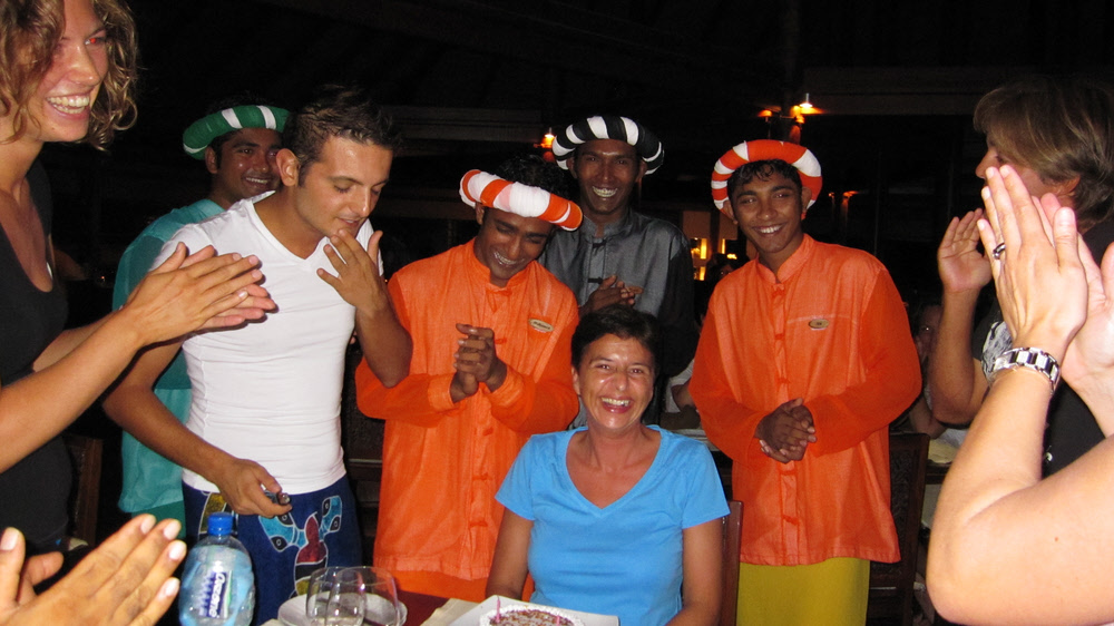 Entertainment staff and waiters wish Happy Birthday to a fellow-guest on Maldivian Night. Our waiter Ziyaad is in black at the back.  (191k)