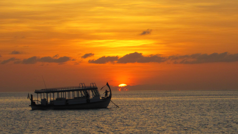 Securing the boat for the night as the sun sets.