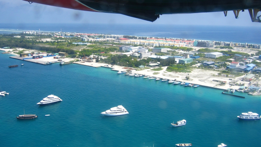 Shortly after take-off from the seaplane terminal, in the Twin Otter on the way to Thudufushi. This is a man-made island to support 
						Male's growing population.