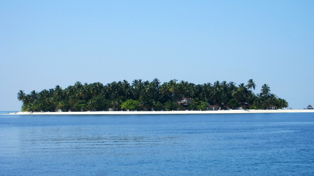 Thudufushi Island from the sea. You can hardly see any buildings from this distance.