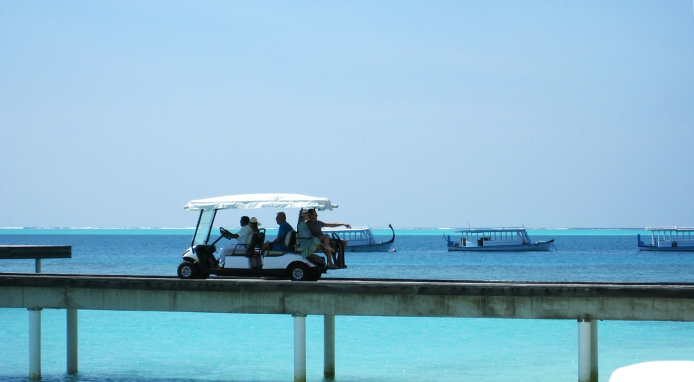 Electric buggies dart up and down the Water Village jetty to save the poor feet of the Village residents.