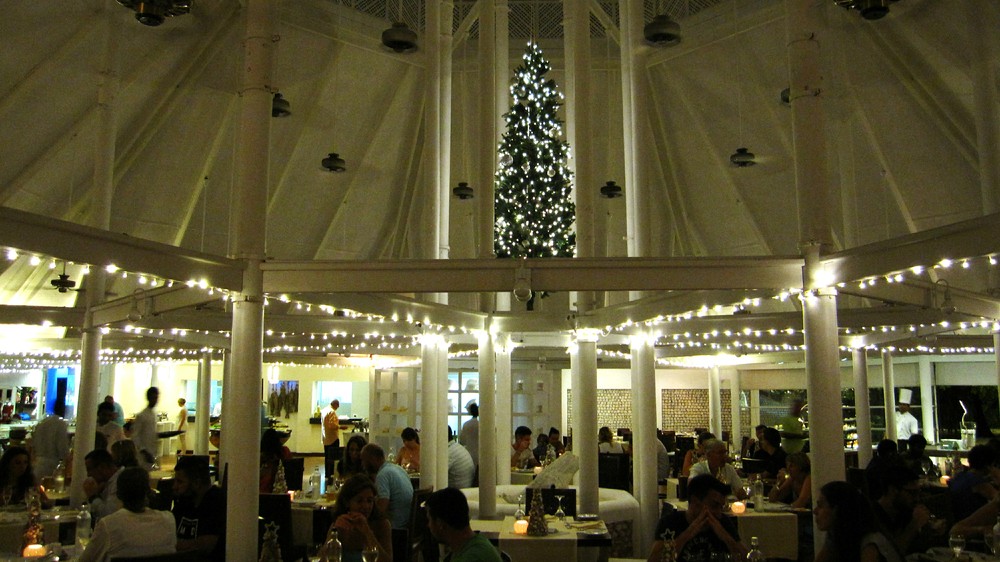 Diners in the Main Restaurant, with another Christmas tree hanging from the ceiling.