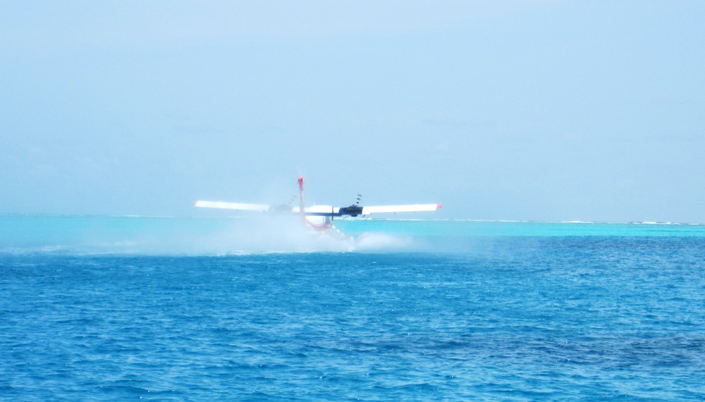 A Twin Otter seaplane takes off in a cloud of spray from Thudufushi lagoon.