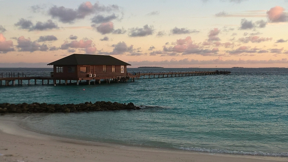 The south jetty at sunset. The dive dhonis are normally moored this side of the storage building.