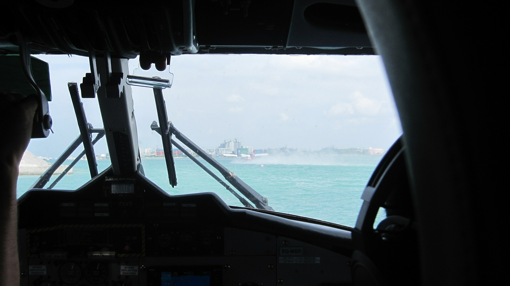 Waiting our turn for take-off at Malé. Looking over the seaplane pilot's shoulders as he watches another seaplane take off.