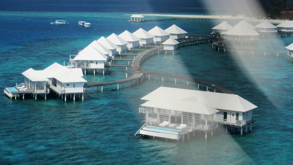 The two luxury Water Villa suites, complete with plunge pools, seen through the propellor a few seconds before touch down.