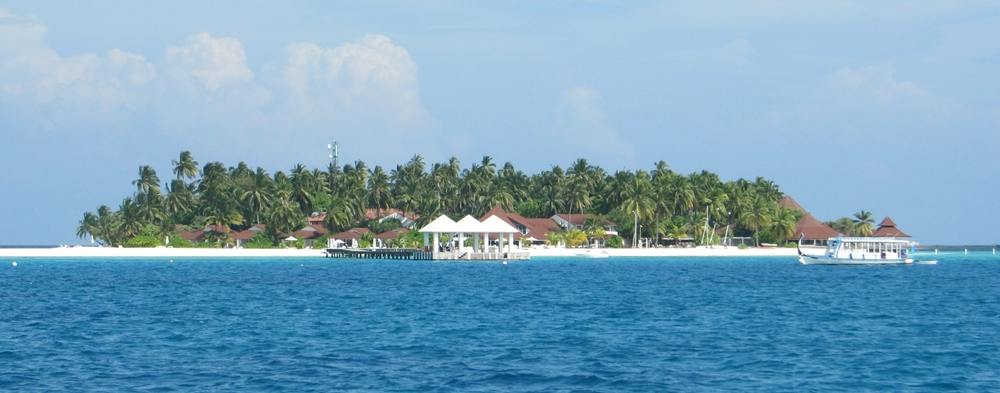 We've transferred from the seaplane onto a dhoni for the short boat ride to the main jetty where the reception committee waits.