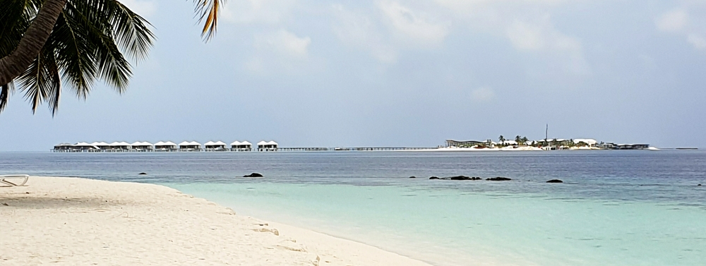 The view from the beach outside our villa towards Innafushi. Work progresses slowly on the new luxury resort. Nearly 
            all the water villas now have roofs, and some of them have walls. The rest of the island is a building site, with 
            workers' accommodation consisting of tin shacks mounted on scaffolding poles out over the ocean.