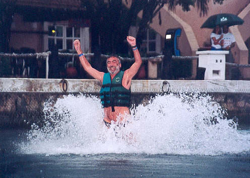 John being pushed along by two dolphins, one under each foot. (36k)