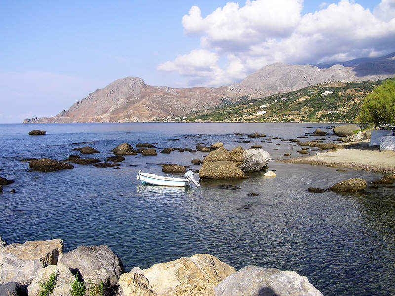 Looking west from the jetty towards Souda Bay (round the green cape, and in front of the rocky cape).  (101k)