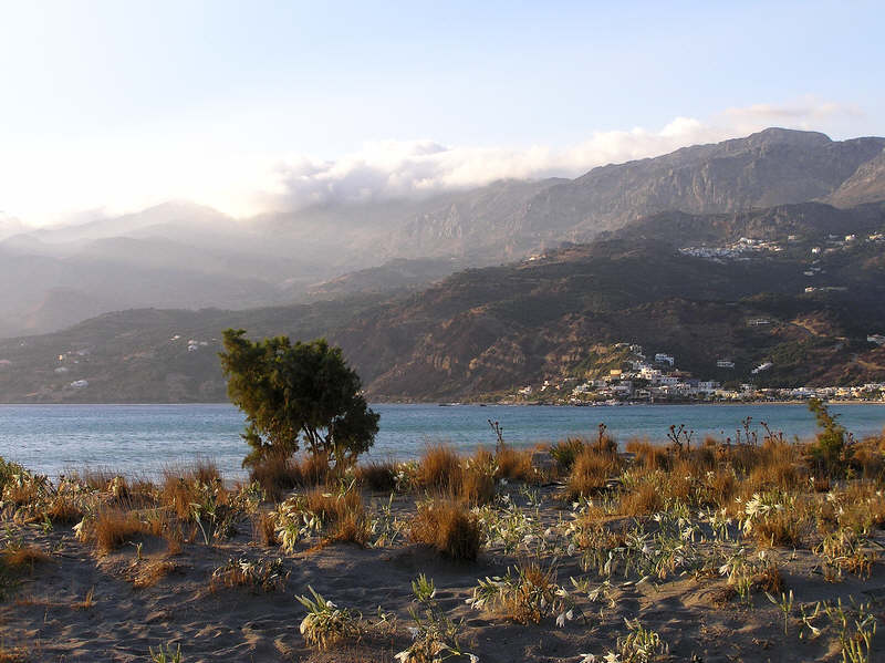 Plakias (and Sellia above and behind it) from the far end of the beach one evening.  (79k)