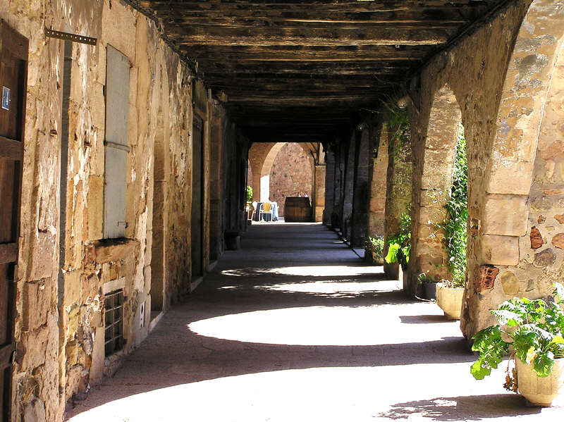 Cloistered sidewalk in Santa Pau.  (99k)