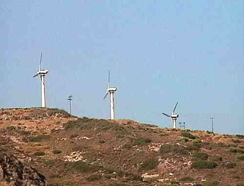 We saw a couple of wind farms, one near Pythagorion, and one near Marathokambos - each
            an array of a dozen or so large propellers on tall masts turning in the stiff meltemi.