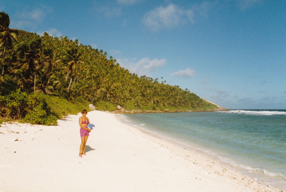 Linda searching for a space to lay the towel down on a crowded beach on Frigate.