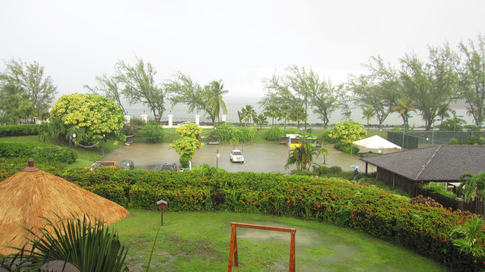 Torrential rain towards the end of our stay flooded the car park. (140k)