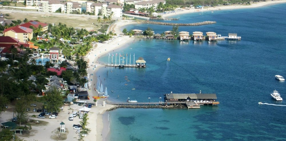 And the view from Signal Peak, showing the boat dock pier, the wedding pier and the over-water villas causeway. You can also make out the empty plot
        beyond Sandals, where they are to build a new hotel.