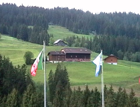 View of Ida Emmenegger's farmhouse from Sörenberg. The living accommodation is on the left - the big barn full of cows is next to it.
            Our kitchen window is just under the eaves to the right of the drainpipe, with a superb view down to the village (see below).