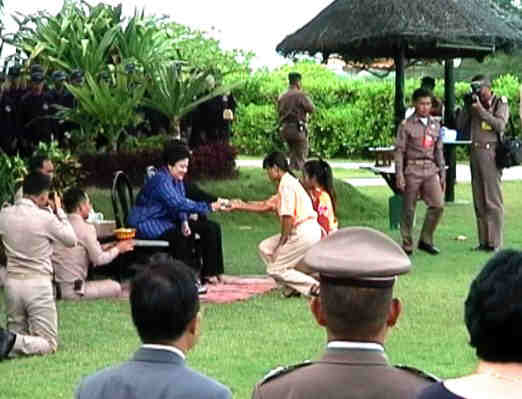 The Princess presenting prezzies to the hotel staff.