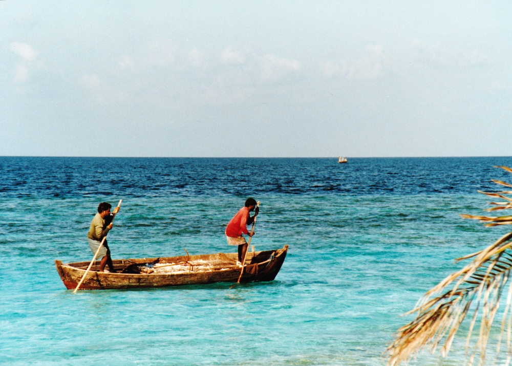 Local workmen setting off to rebuild some of the coral walls protecting the beaches.