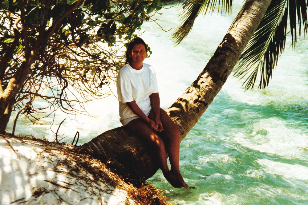 Linda perched on a palm tree just outside our room at high tide.