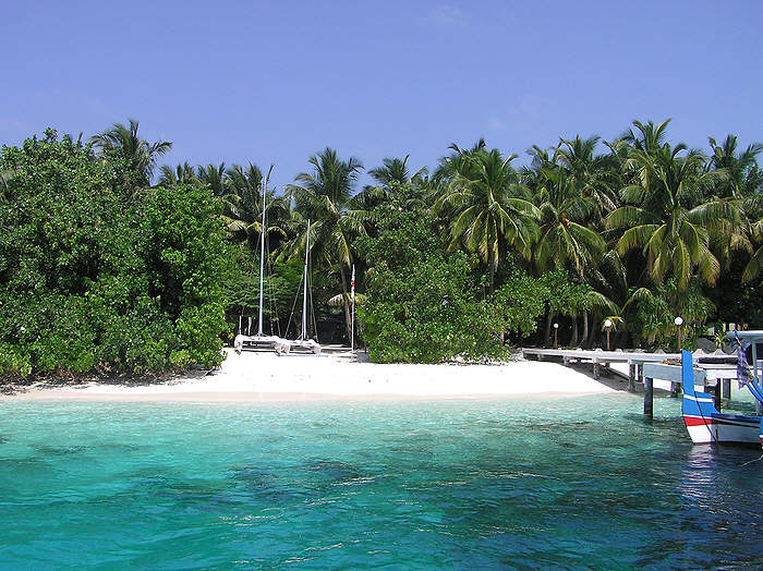 Next to the dive jetty. The watersports centre has a couple of hobie cats and some windsurfers. The dive centre is just beyond the cats, hidden in the trees.  (94k)