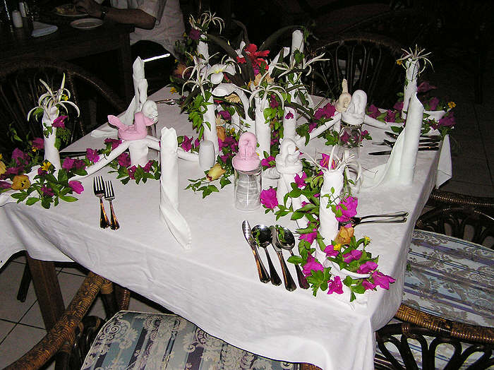 On our last night our waiter decorated our table with flowers and folded napkins.  (88k)